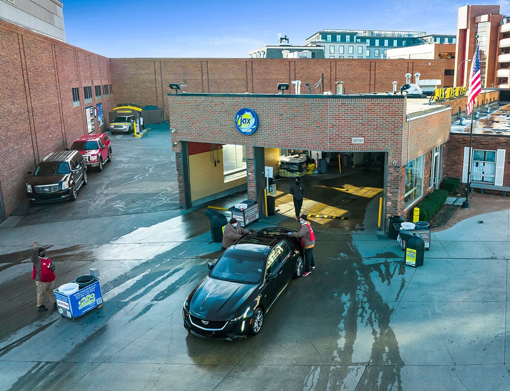 A vehicle being hand dried at a Jax Kar Wash location